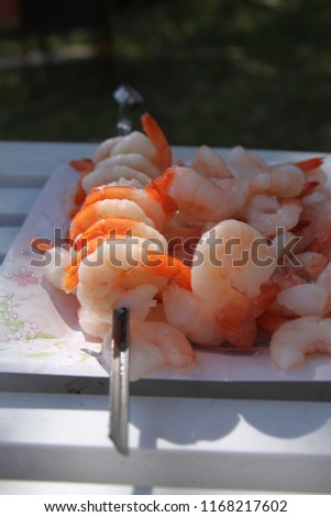 Grilled shrimp skewers. Seafood, shelfish. Shrimps Prawns skewers with herbs, garlic and lemon on black stone background, copy space. Shrimps prawns brochette kebab. Barbecue srimps prawns.