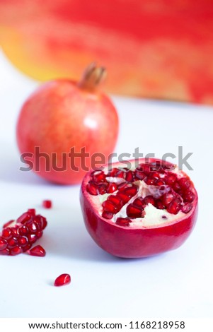 Ripe red pomegranate with seeds on white background. close-up photo