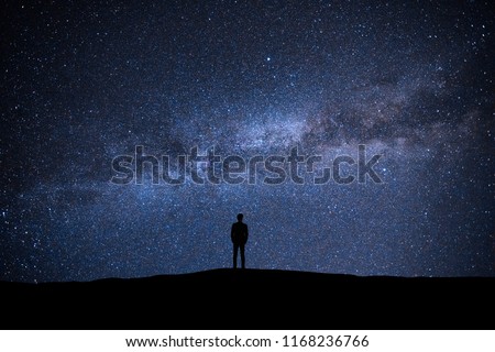 The man standing on the picturesque starry sky background