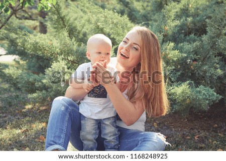Happy beautiful mother and baby daughter or son