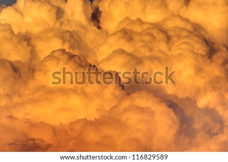 detail of orange clouds illuminated by the warm sunset