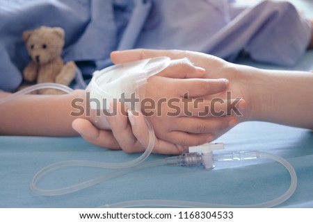 Mother holding child's hand who fever patients in hospital to give encouragement. Royalty-Free Stock Photo #1168304533