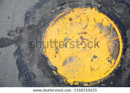 the entrance to the sewers with yellow cap