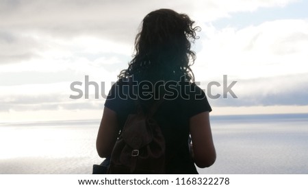 a beautiful girls silhouette against a sunset.