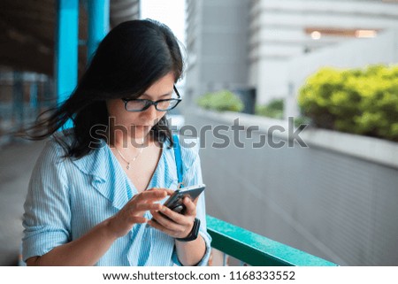 Young woman use smartphone on Footbridge