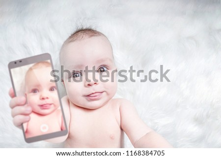 Funny baby girl taking selfie with tongue out