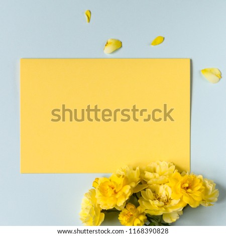 Yellow horizontal card with roses on the blue background. Copy space