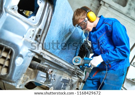 collision repairs service. mechanic grinding car body by grinder Royalty-Free Stock Photo #1168429672