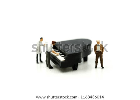 Miniature people : man play mini piano using for concept of music and International Podcast Day