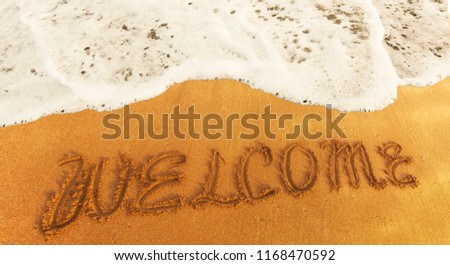 inscription WELCOME on the yellow  sand