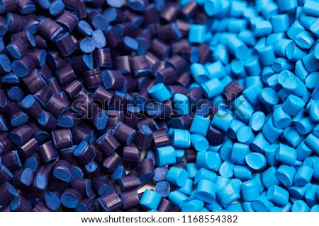 Close up of a two stacks of blue plastic polypropylene granules on a table Royalty-Free Stock Photo #1168554382