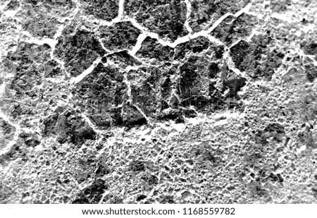 Dark dried and cracked earth background texture, black and white photo