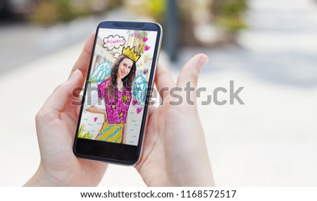 Phone displaying an app where you can put stickers and effects on a photograph