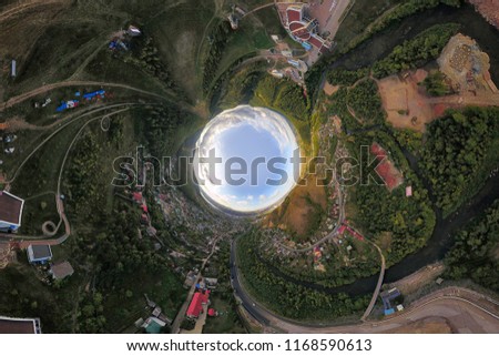Helicopter drone shot. Aerial photography of a modern city over an area, a large crossroads, high-rise buildings, a park and roads. Panoramic city 360  shot from above