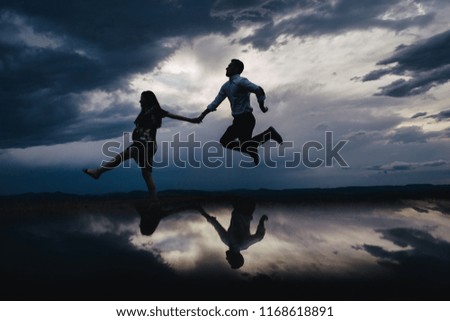 Silhouette of a pregnant woman with her husband starting a new life together. 