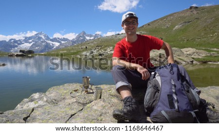 Smiling Active Young Man in Outdoors With Mountains in Background - Model Released