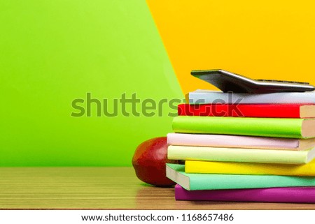red apple and old books on wooden tabletop