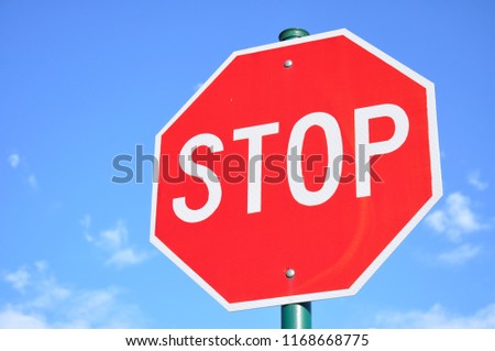 Stop sign against blue sky.