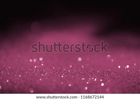 abstract blurred pink glitter on dark background