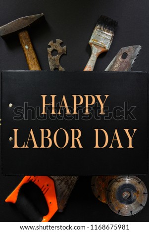 Construction worker tool builder hammer, saw, nails, screwdrivers on black background flat  lay top view , concept of work and business and national holiday Labor Day