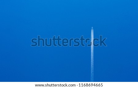 Large passenger aircraft in blue cloudless sky