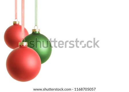 Hanging red and green christmas baubles isolated on white background.