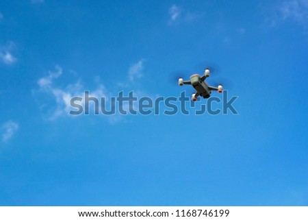 Drone flying against a blue sky. Empty copy space for Editor's text.