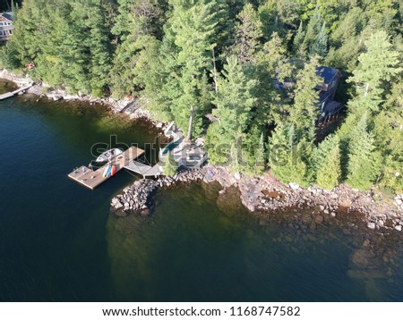 This is a photo of a part of Canada that is on a body of water, the water is very calm and this photo has such a great landscape.
