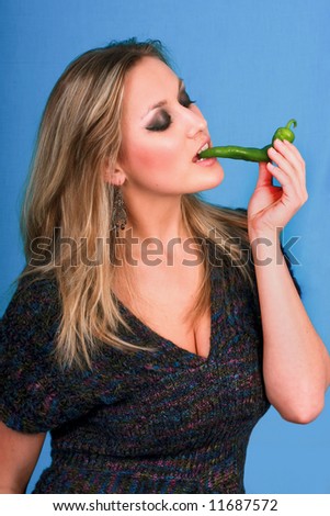 woman eating green hot papper blue screen