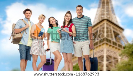 summer holidays, tourism and vacation concept - group of happy friends with travel bags, air tickets and camera over eiffel tower background