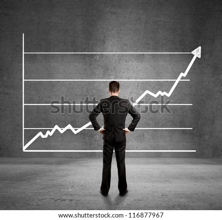 businessman looks at growth chart