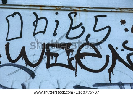 Beautiful street art graffiti in style of tag. Abstract creative tags of fashionable styles on city walls. Urban contemporary culture. Abstract stylish tagging drawing, sticker on wall, graffiti style