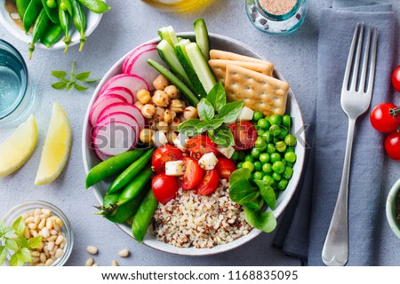 Healthy vegetarian salad. Buddha bowl. Grey stone background. Top view.