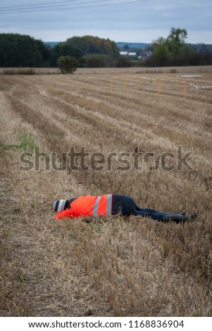 A man lying on the ground in a fiedl 