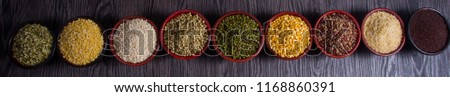 Various bowls of spices over wooden background. Colours and textures