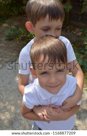 Two brothers hold hands and hug each other