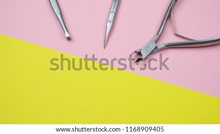 Composition With Manicure Tools. Scissors For Nails, Tweezers, Forceps On The Geometric Pastel Pink And Yellow Colors Background Minimal Style Flat Lay Copy Space Long Banner