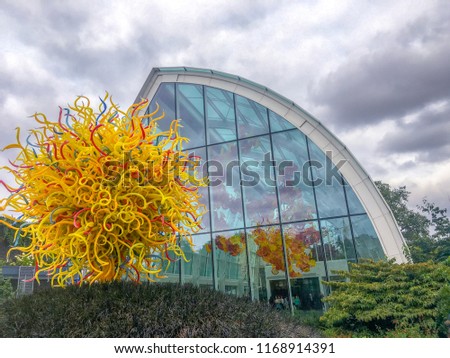 Glass artwork in Seattle against glass windows