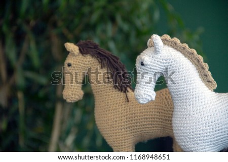 two crocheted amigurumi horse toy profiles