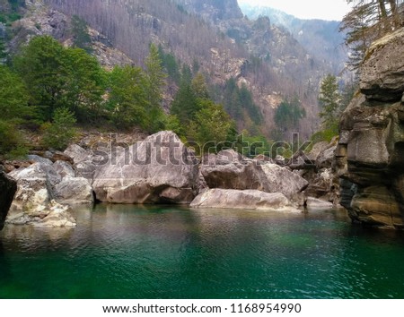 
journey mountain blue lake, a river among rocks and rocks.