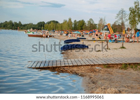 Lake beach with air mattresses. Nice landscape of lake vacation. Travel picture series
