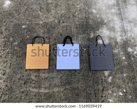Background of paper bags shopping bags in brown, white and black colors