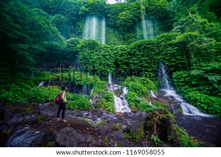 Picture of female tourist enjoying a beautiful scenery of Benang Kelambu waterfall in Lombok, Indonesia