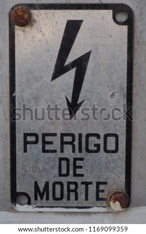 Close-up of a weathered high voltage warning sign   