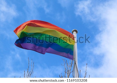 Gay Pride Flag with Blue Sky Background