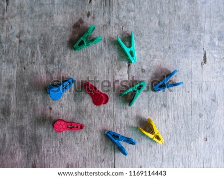 Colorful clothespins on old wood background.