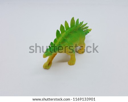 Toys statue Dino pole Green, yellow, made of plastic background and White