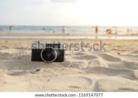 Film camera placed on the beach.