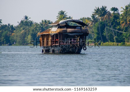 Travel tourism Kerala background - houseboat on Kerala backwaters. Kerala, India
