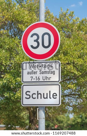 Traffic signs for speed limit on 30 km/h, on workdays in the area of a school in the time of from 7 to 16 o'clock